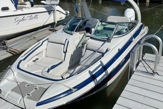 Slide: The Image of 2021 Crownline Eclipse E255 XS boat docked, featuring sleek design and spacious seating. - 9