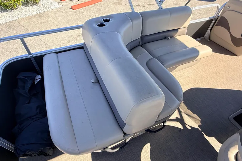 Slide: The Image of 2023 Sun Tracker Party Barge 18 DLX interior seating with cup holders, beige upholstery. - 15