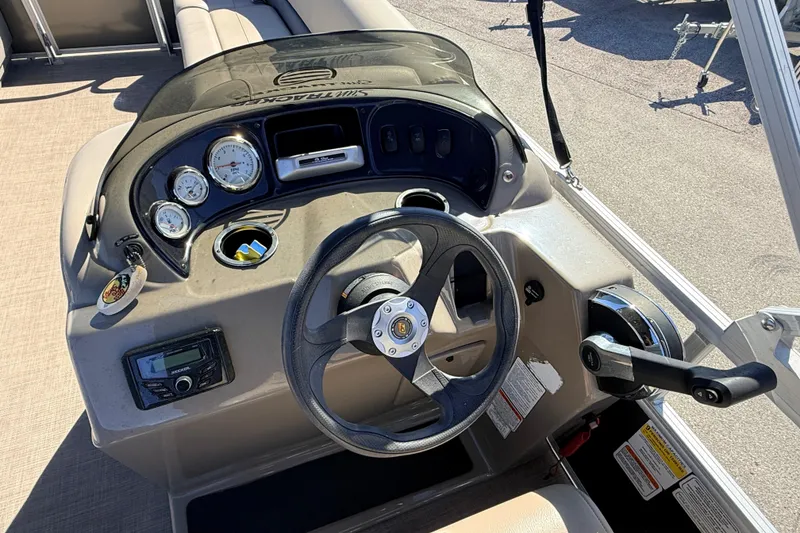 Slide: The Image of 2023 Sun Tracker Party Barge 18 DLX dashboard with steering wheel and controls. - 17