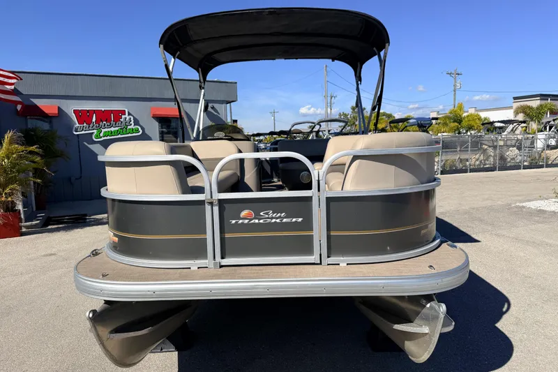 Slide: The Image of 2023 Sun Tracker Party Barge 18 DLX pontoon boat at dealership under clear blue sky. - 3