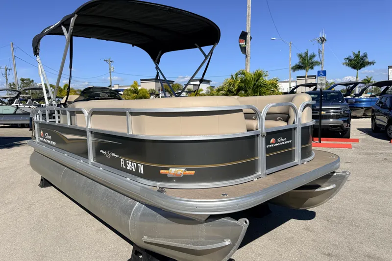 Slide: The Image of 2023 Sun Tracker Party Barge 18 DLX pontoon boat in a parking lot. - 4