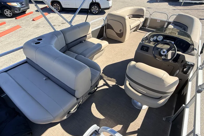 Slide: The Image of 2023 Sun Tracker Party Barge 18 DLX interior with plush seating and modern dashboard. - 8