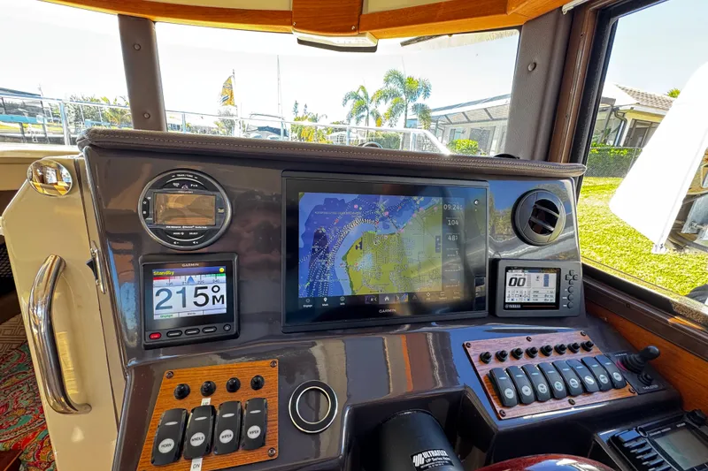 Slide: The Image of 2020 Ranger Tugs R-25 helm with navigation displays and control panels. - 13