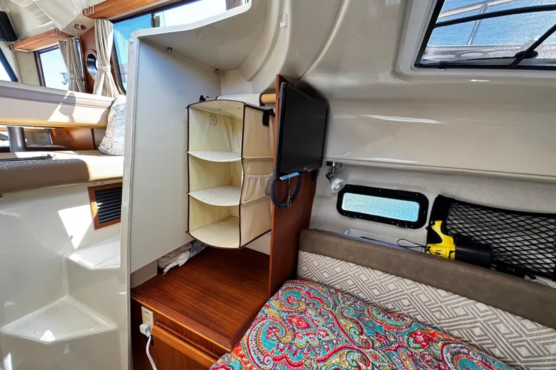 Slide: The Image of Interior of 2020 Ranger Tugs R-25 boat with cozy cabin and storage. - 15