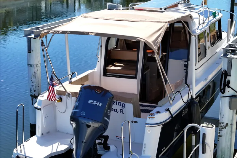 Slide: The Image of 2020 Ranger Tugs R-25 boat docked, featuring a Yamaha 250 outboard motor. - 3