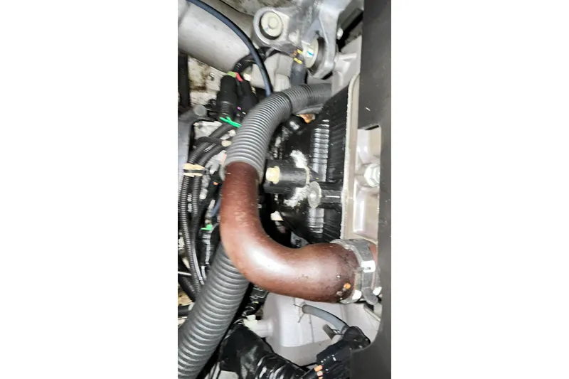 Slide: The Image of Engine components of a 2017 Yamaha WaveRunner FX Cruiser SVHO, featuring hoses and wiring. - 27