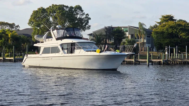 Slide: The Image of 1998 Navigator 5300 yacht on calm water near dock. - 1