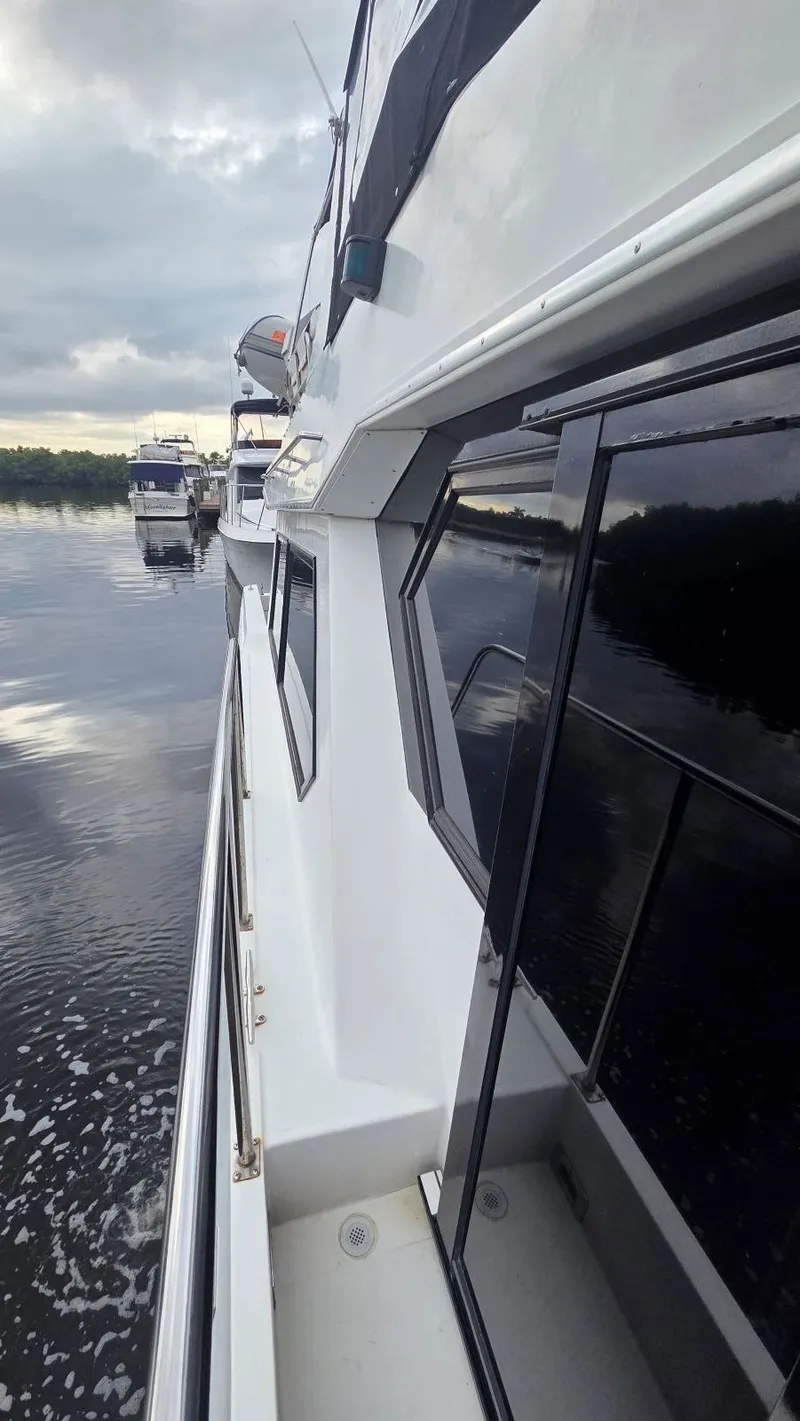 Slide: The Image of Side view of Navigator 5300 yacht on calm water. - 13