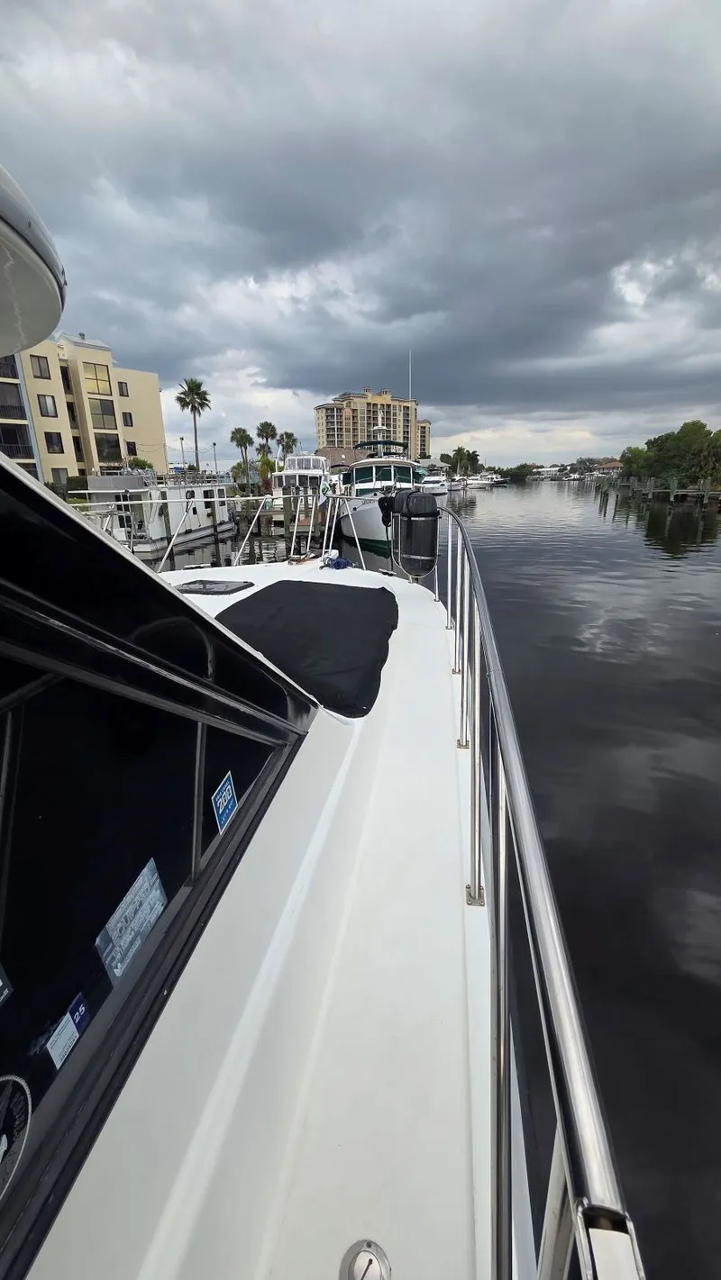 Slide: The Image of 1998 Navigator 5300 yacht on calm water under cloudy skies. - 14