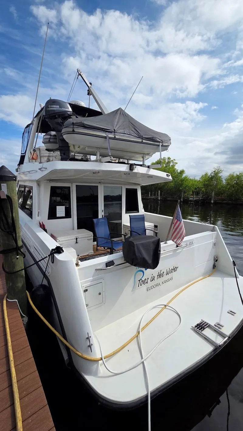 Slide: The Image of 1998 Navigator 5300 yacht docked with blue chairs. - 15