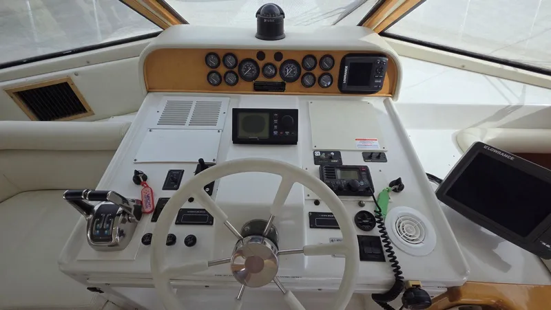 Slide: The Image of Navigator 5300 1998 helm with instruments and controls. - 41
