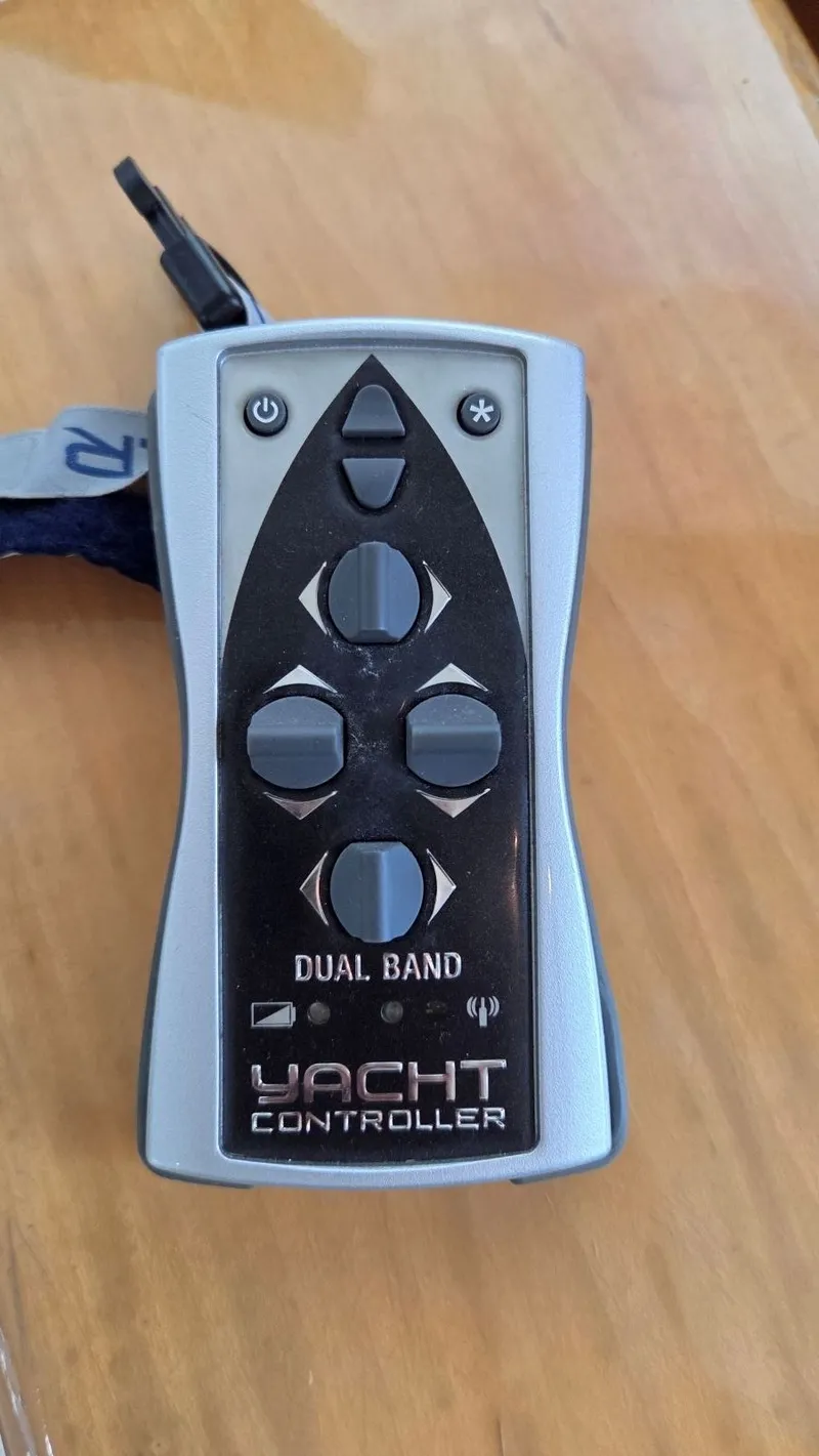 Slide: The Image of Yacht controller with dual band feature on wooden table. - 44