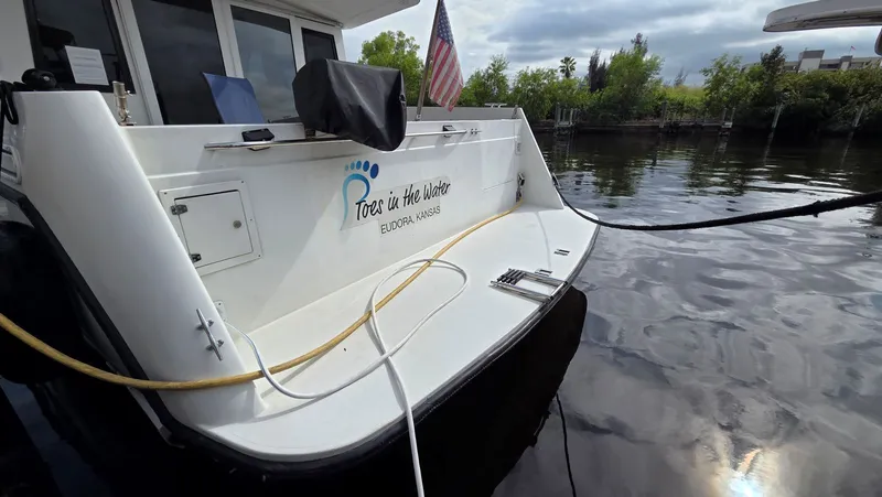 Slide: The Image of Stern of a 1998 Navigator 5300 boat by the water. - 6
