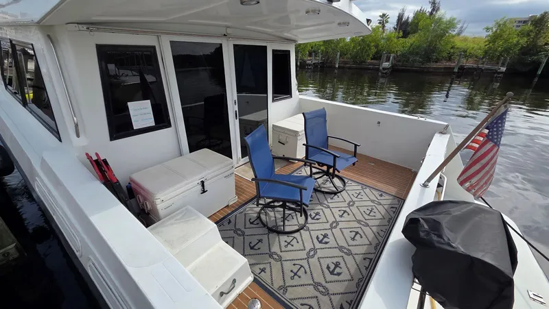 Slide: The Image of Deck of a 1998 Navigator 5300 with chairs and rug. - 8