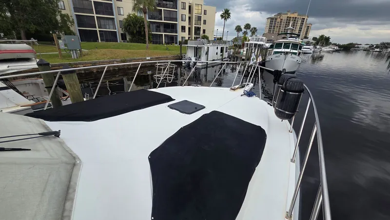 Slide: The Image of 1998 Navigator 5300 yacht docked, surrounded by buildings. - 9