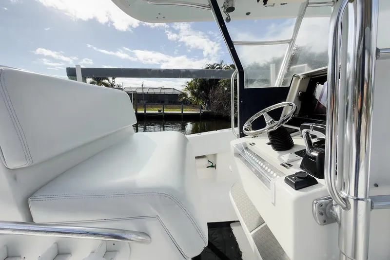 Slide: The Image of 2007 Invincible 33 Open Fisherman boat interior with steering wheel and seating. - 10