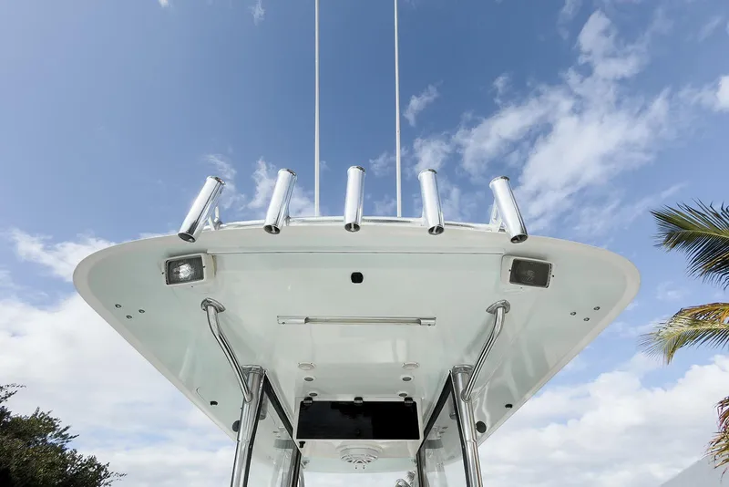 Slide: The Image of 2007 Invincible 33 Open Fisherman boat, view of T-top and rod holders against blue sky. - 13