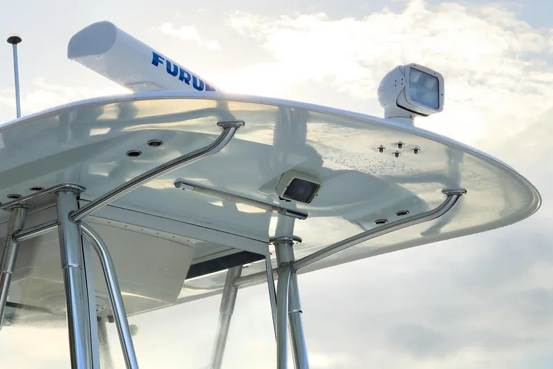 Slide: The Image of 2007 Invincible 33 Open Fisherman boat's radar and T-top against a cloudy sky. - 14