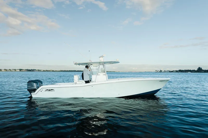 Slide: The Image of 2007 Invincible 33 Open Fisherman boat on calm water under blue sky. - 2