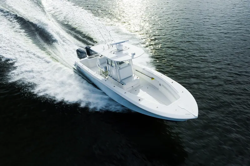 Slide: The Image of 2007 Invincible 33 Open Fisherman boat cruising on open water, creating a wake. - 3