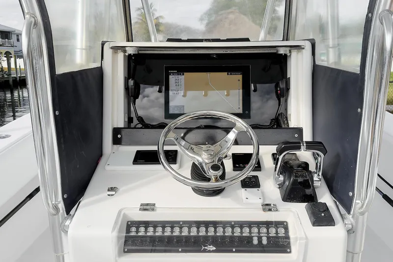 Slide: The Image of Console of 2007 Invincible 33 Open Fisherman with steering wheel and navigation display. - 8