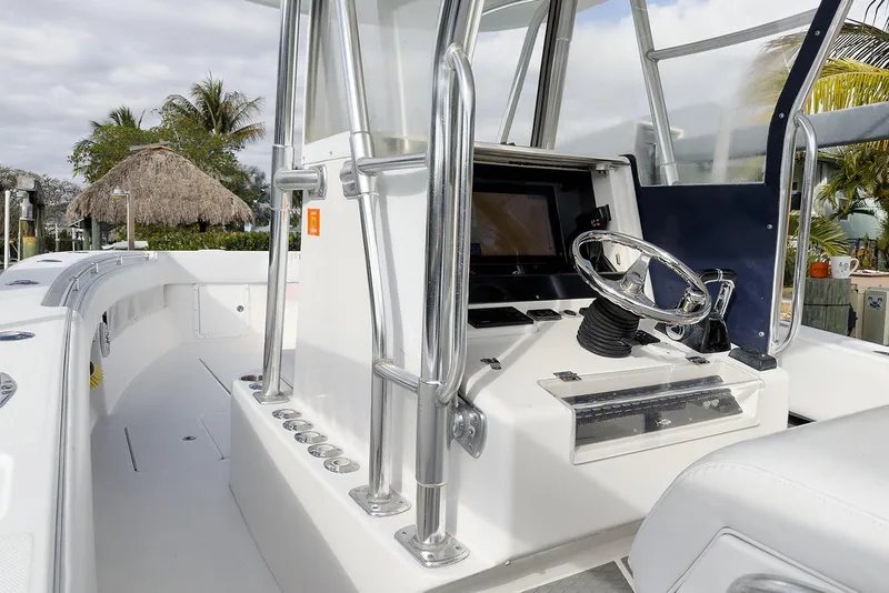 Slide: The Image of 2007 Invincible 33 Open Fisherman boat cockpit with steering wheel and navigation equipment. - 9