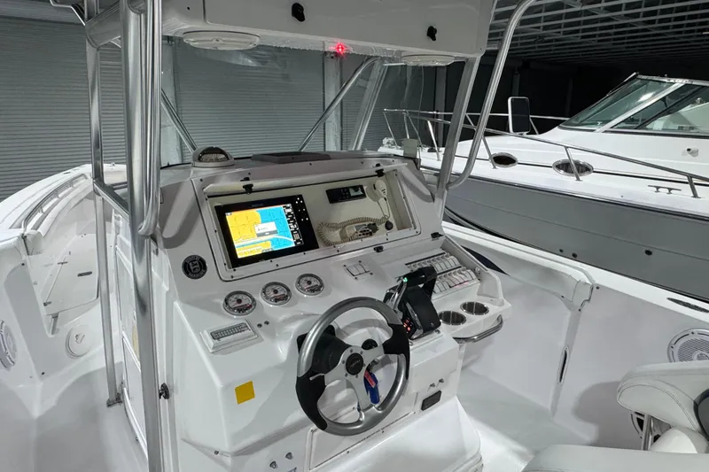 Slide: The Image of 2005 Donzi 32 ZF Open boat cockpit with navigation system and steering wheel. - 10