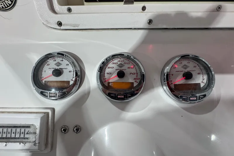 Slide: The Image of Dashboard of 2005 Donzi 32 ZF Open with RPM and speed gauges. - 14