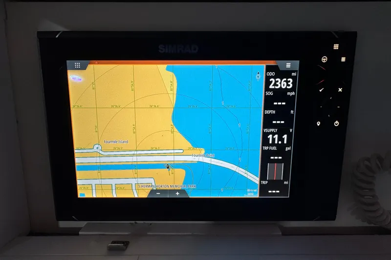 Slide: The Image of Simrad navigation display on 2005 Donzi 32 ZF Open boat, showing map and trip data. - 15