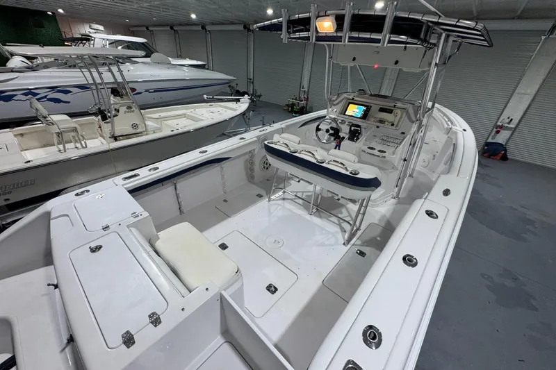 Slide: The Image of 2005 Donzi 32 ZF Open boat interior with helm, seating, and storage in a showroom. - 16