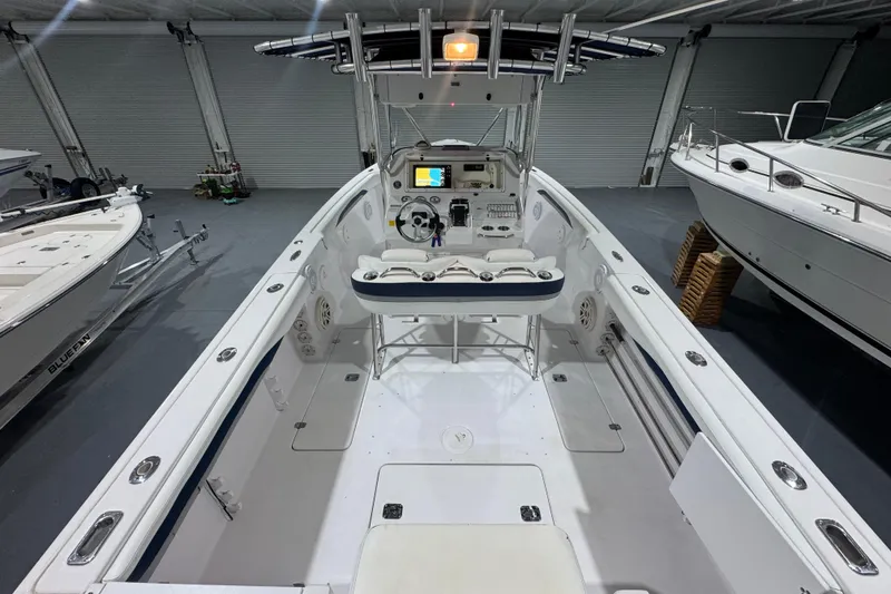 Slide: The Image of 2005 Donzi 32 ZF Open boat interior in a garage, showcasing helm and seating. - 18