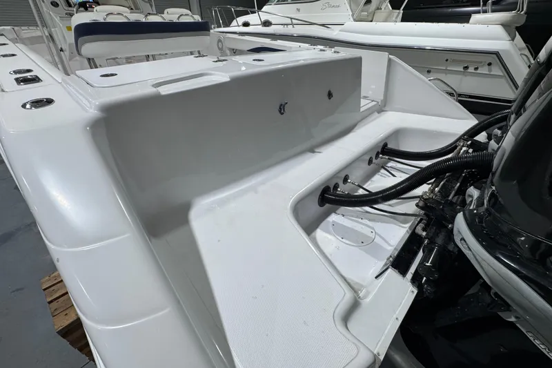 Slide: The Image of 2005 Donzi 32 ZF Open boat interior with seating and engine details. - 19