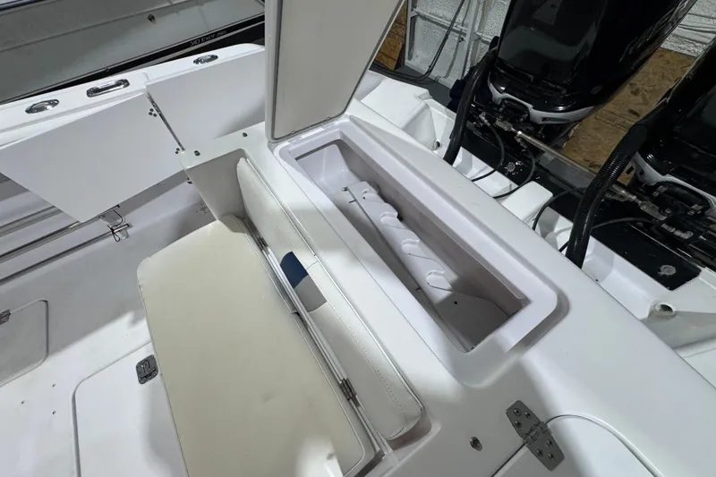 Slide: The Image of 2005 Donzi 32 ZF Open boat interior with storage compartment and dual engines. - 20