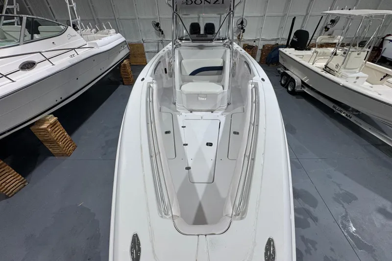 Slide: The Image of 2005 Donzi 32 ZF Open boat in storage, surrounded by other vessels. - 23