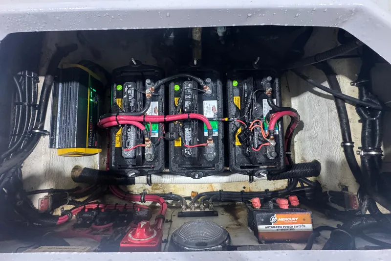 Slide: The Image of Battery compartment of a 2005 Donzi 32 ZF Open boat with wiring and power switch. - 28