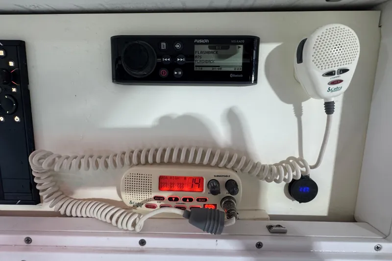 Slide: The Image of Control panel of a 2005 Donzi 32 ZF Open boat with radio and microphone. - 29