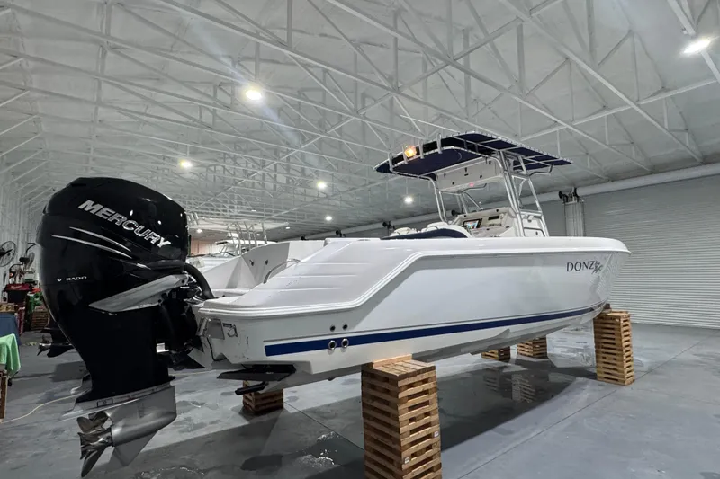 Slide: The Image of 2005 Donzi 32 ZF Open boat with Mercury engine in a spacious indoor storage facility. - 3
