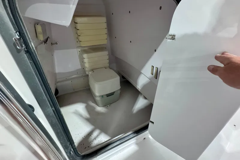 Slide: The Image of 2005 Donzi 32 ZF Open boat interior with compact toilet and storage area. - 31