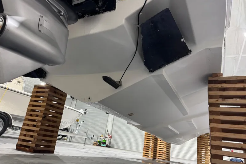 Slide: The Image of 2005 Donzi 32 ZF Open boat hull on wooden supports in a garage. - 32