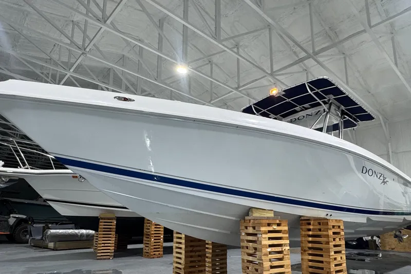 Slide: The Image of 2005 Donzi 32 ZF Open boat in storage, elevated on wooden blocks. - 4