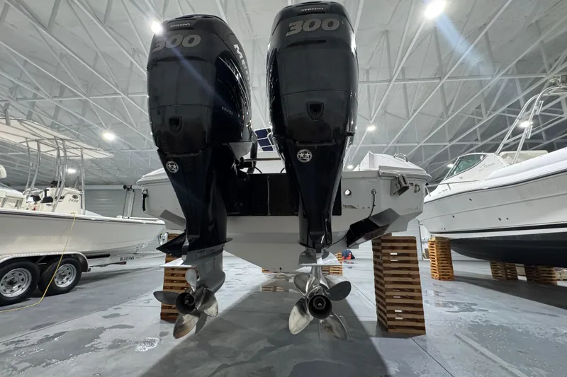 Slide: The Image of 2005 Donzi 32 ZF Open with twin 300 horsepower engines in a boat storage facility. - 5