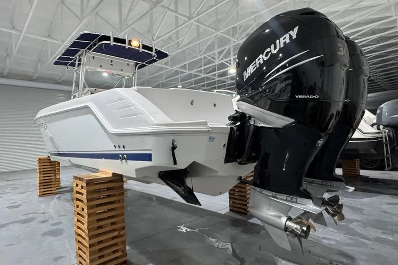 Slide: The Image of 2005 Donzi 32 ZF Open boat with twin Mercury Verado engines in a storage facility. - 6