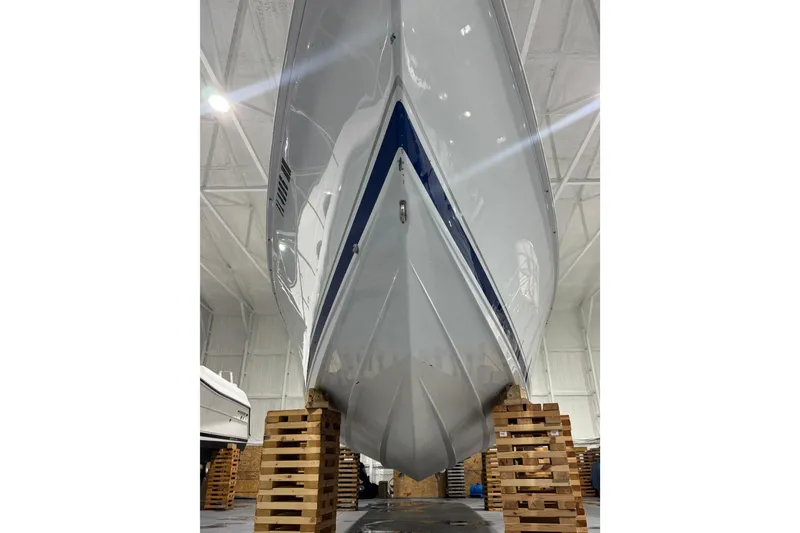 Slide: The Image of 2005 Donzi 32 ZF Open boat hull in storage, elevated on wooden blocks. - 8