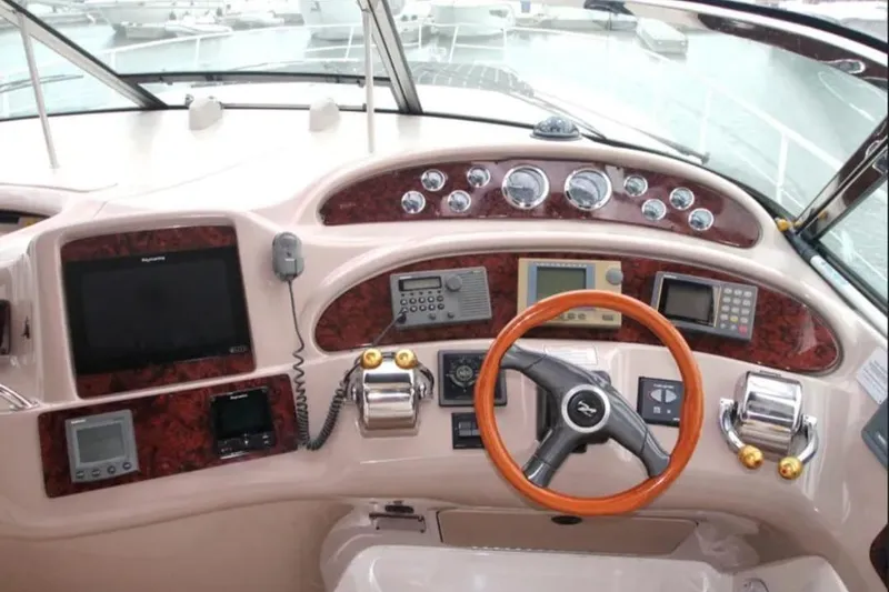 Slide: The Image of Helm of 2001 Sea Ray Sundancer 460 with wood accents and navigation equipment. - 12