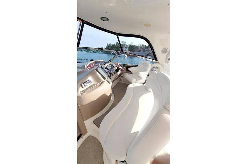 Slide: The Image of Interior view of 2001 Sea Ray Sundancer 460 yacht with luxurious seating and helm. - 19