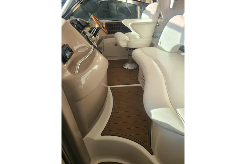 Slide: The Image of Interior of 2001 Sea Ray Sundancer 460 yacht with white seating and wooden flooring. - 25