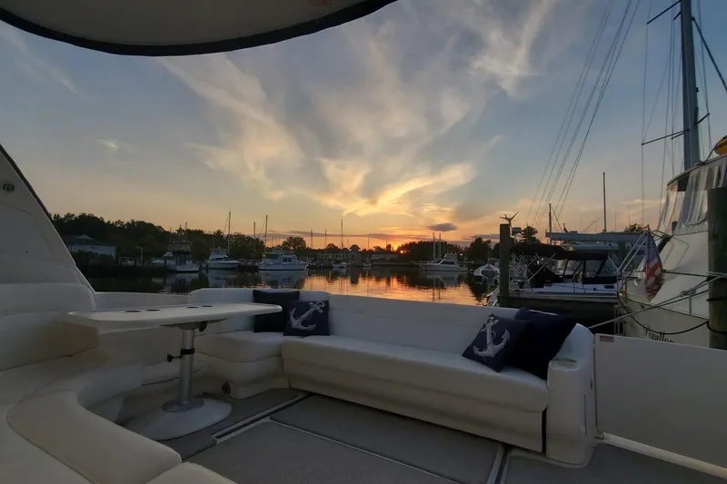 Slide: The Image of 2001 Sea Ray Sundancer 460 yacht interior at sunset, marina view with boats and calm water. - 26