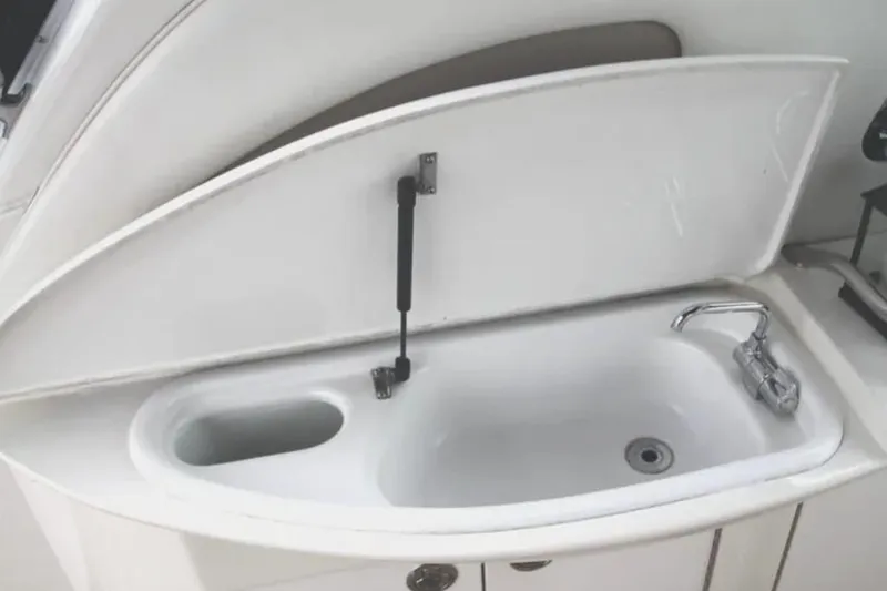 Slide: The Image of 2001 Sea Ray Sundancer 460 yacht sink with open cover and chrome faucet. - 27