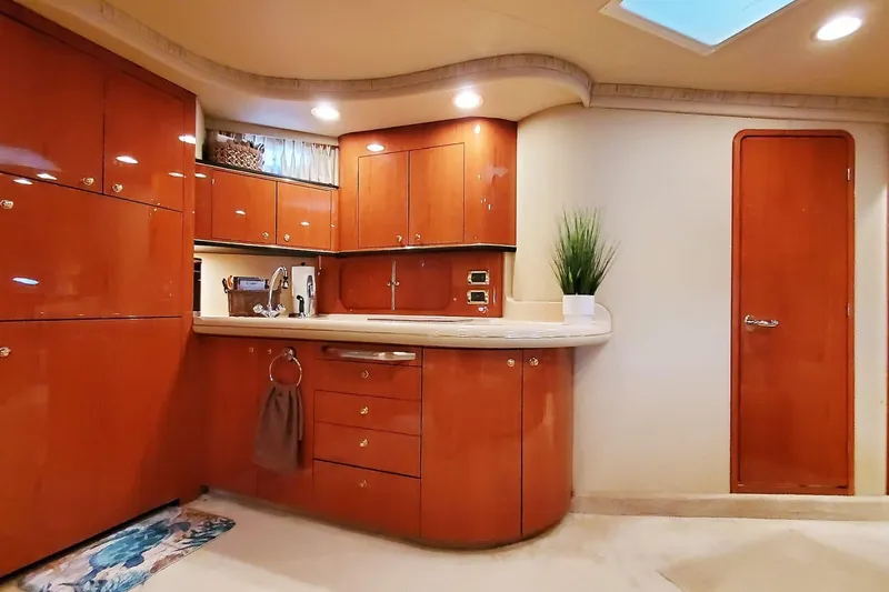 Slide: The Image of Luxurious 2001 Sea Ray Sundancer 460 yacht interior with polished wood cabinetry and modern amenities. - 34