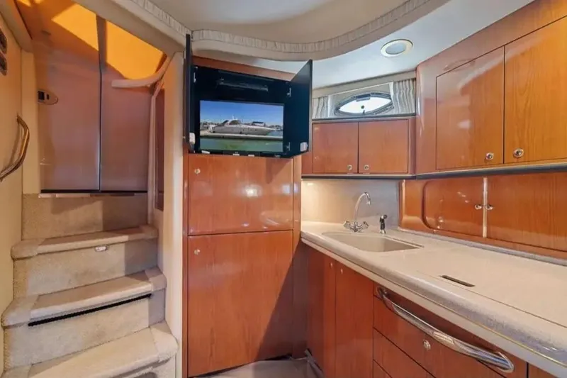 Slide: The Image of Interior of 2001 Sea Ray Sundancer 460 yacht with wooden cabinetry and modern amenities. - 37
